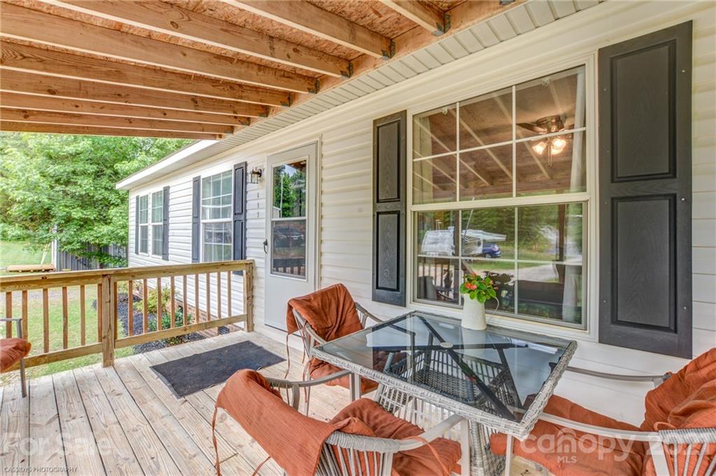 1968 Steel Hill Road Lancaster, SC 29720 - Photo 10 of 28 a view of a patio with table and chairs with wooden floor and fence