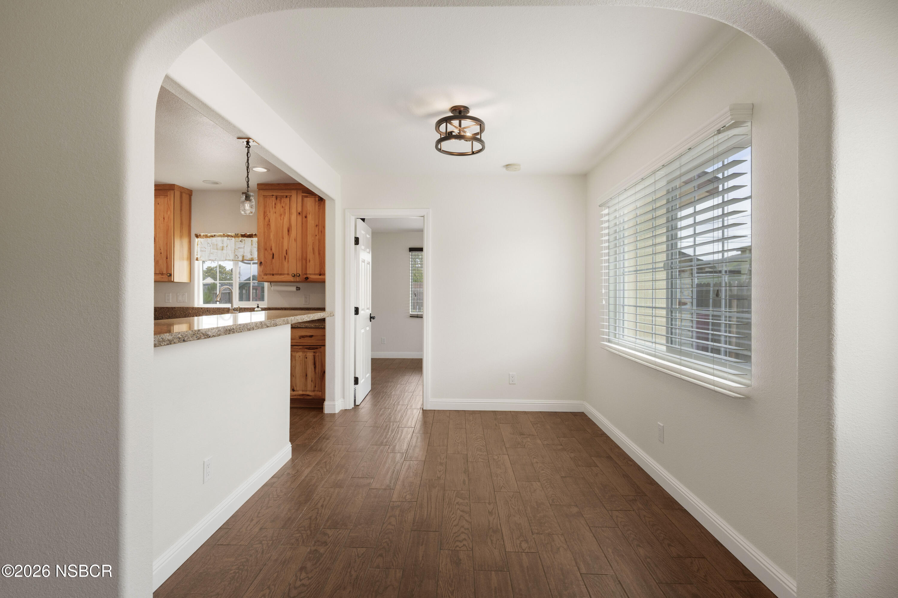 138 North E Street Lompoc, CA 93436 - Photo 10 of 35 a kitchen with a refrigerator and wooden floor
