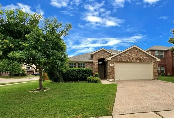 a front view of a house with a garden and yard