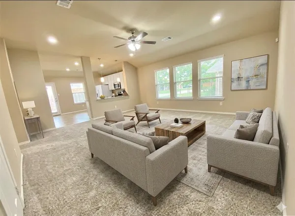 a living room with furniture and a large window