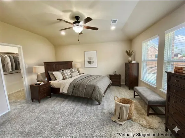 a spacious bedroom with a bed and wooden floor