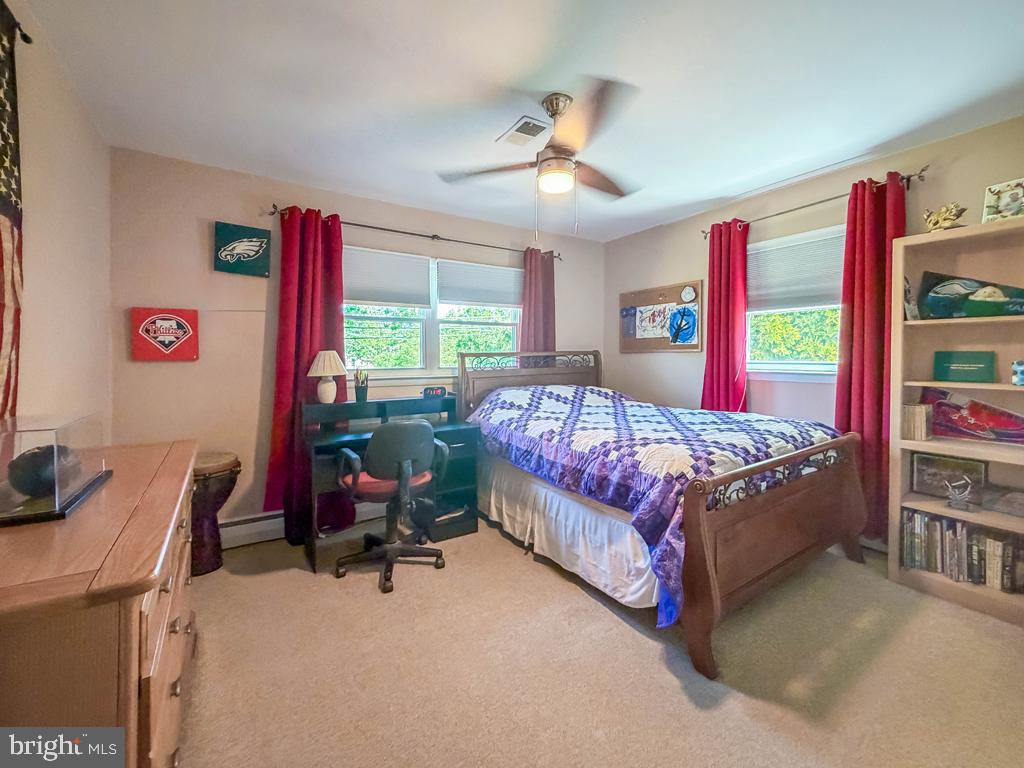 925 Big Oak Road Yardley, PA 19067 - Photo 34 of 51 a bedroom with a bed and a chandelier