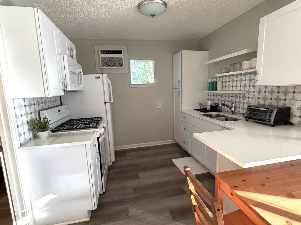 2208 Garden Street, Unit B Austin, TX 78702 - Photo 5 of 10 a kitchen that has a sink a stove and a refrigerator