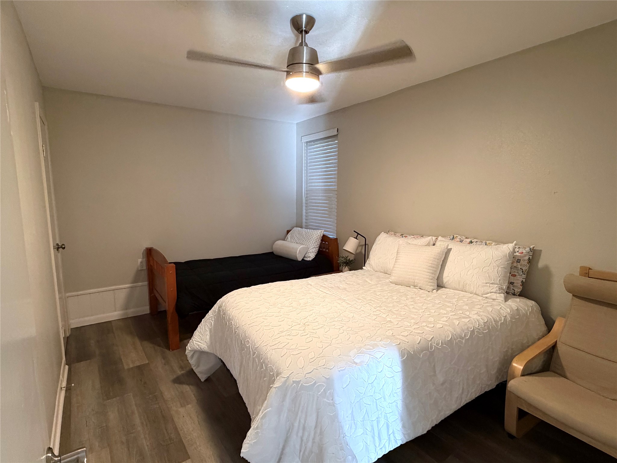 2208 Garden Street, Unit B Austin, TX 78702 - Photo 6 of 10 a bedroom with bed and a chandelier