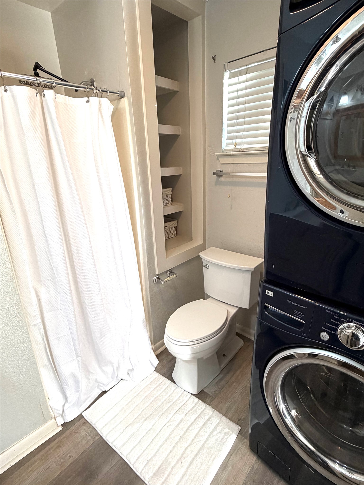 2208 Garden Street, Unit B Austin, TX 78702 - Photo 9 of 10 a bathroom with a toilet a sink and a mirror