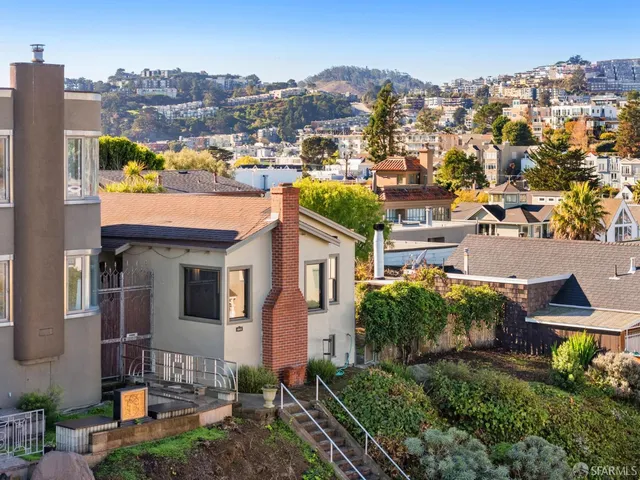 an aerial view of a house with a yard basket ball court and outdoor seating
