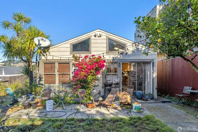 a backyard of a house with table and chairs