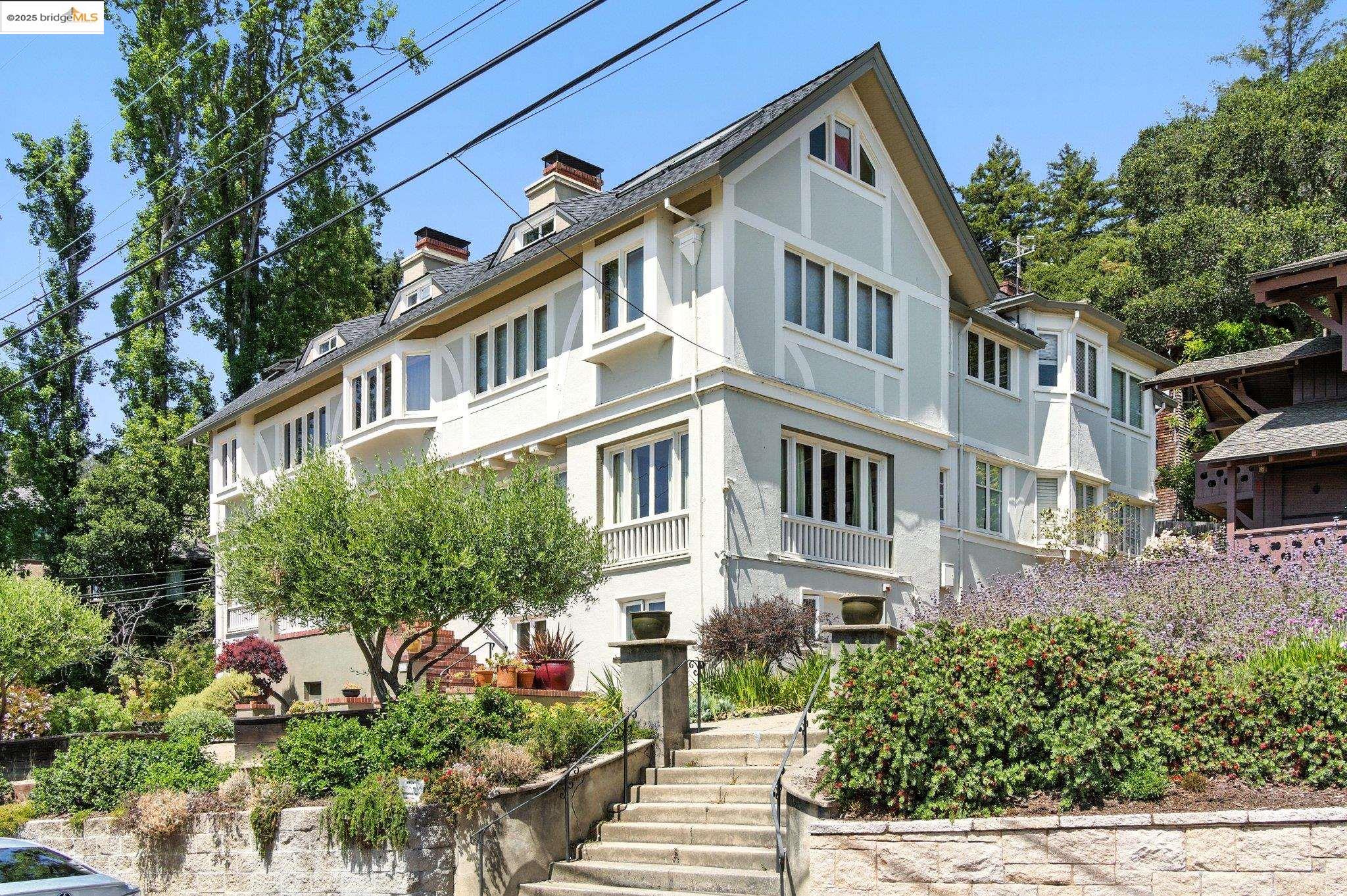 a front view of a multi story building with a yard