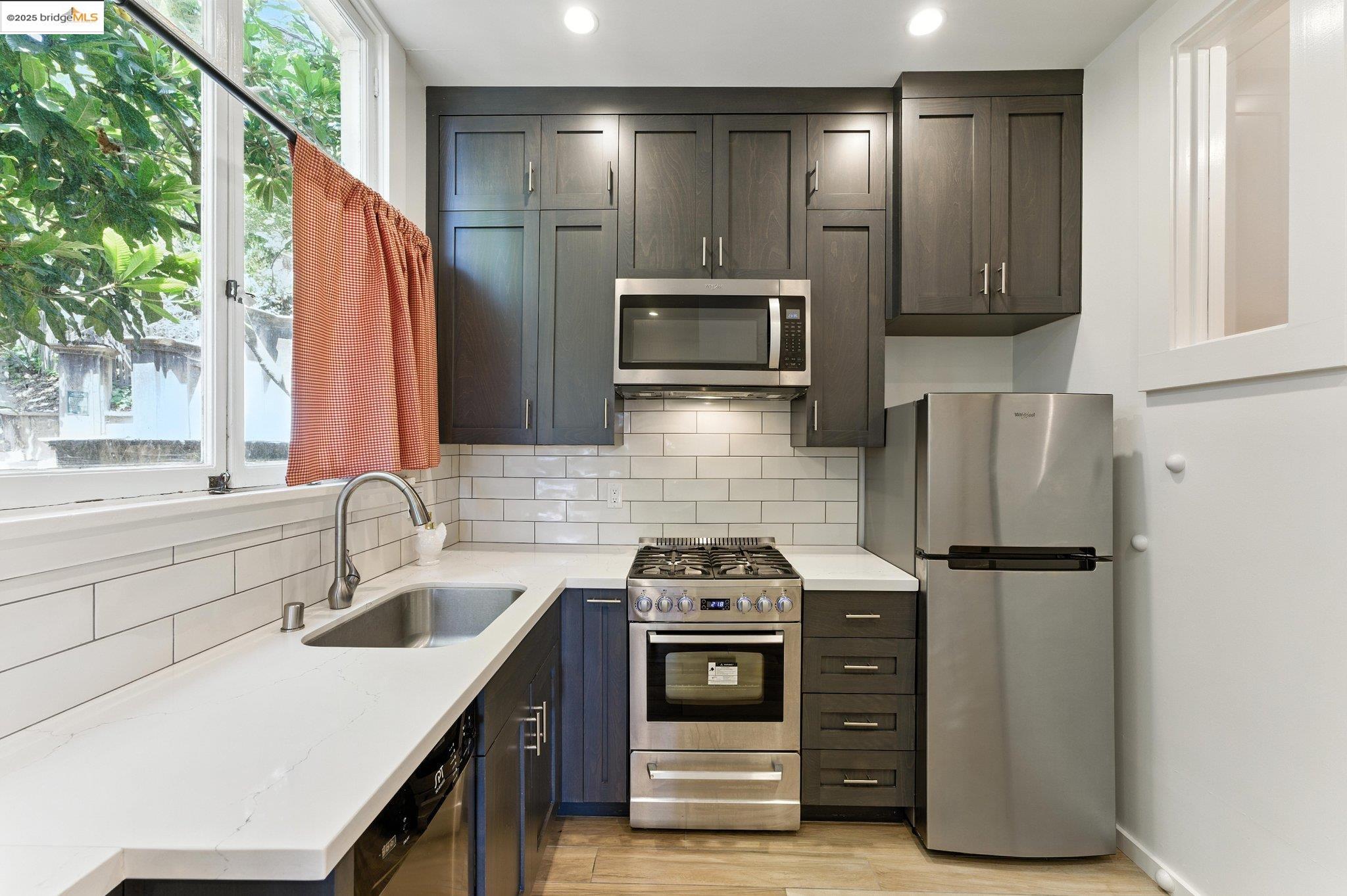 7 Panoramic Way Berkeley, CA 94704 - Photo 19 of 47 a kitchen with stainless steel appliances a stove microwave and refrigerator
