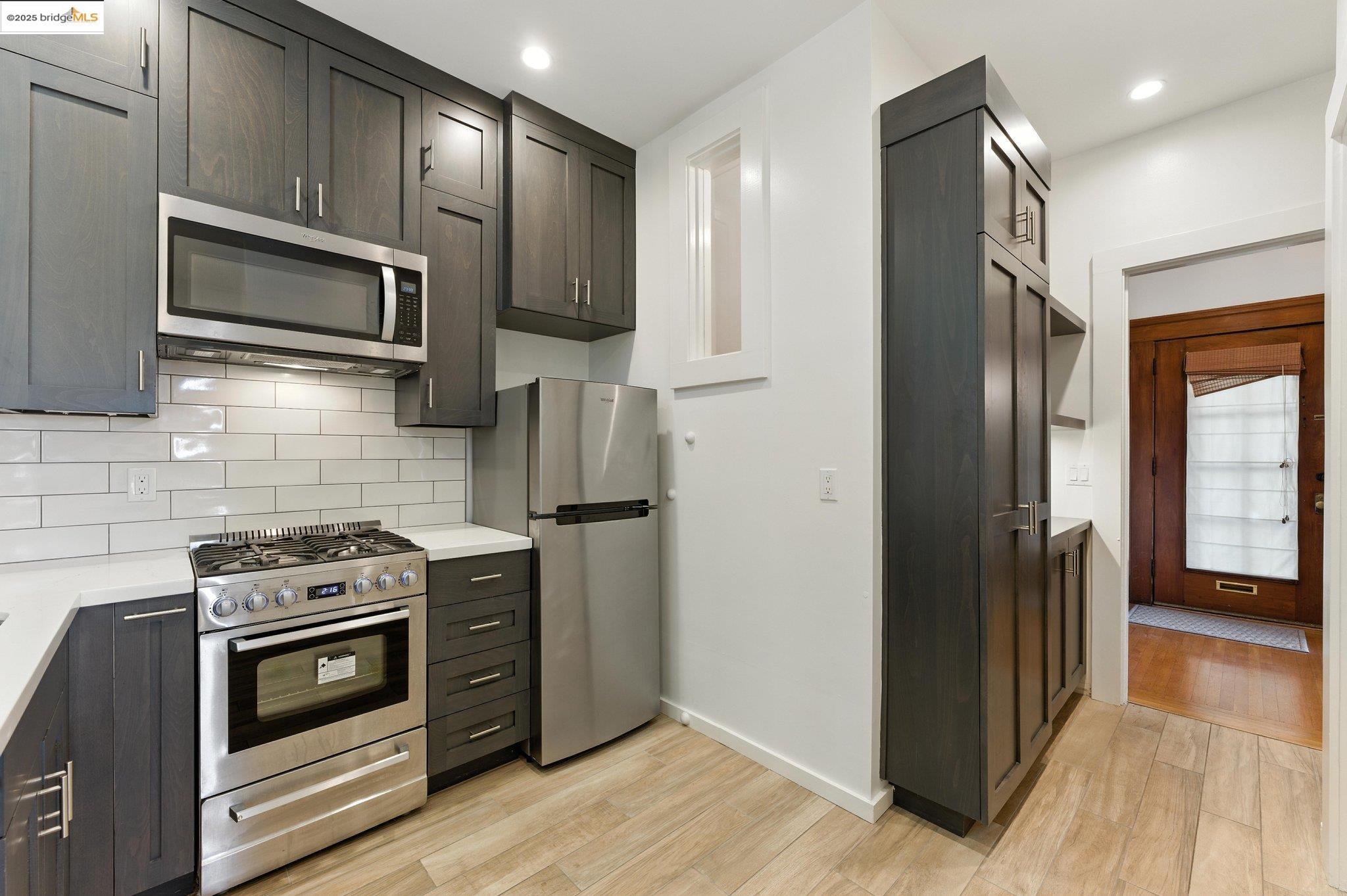 7 Panoramic Way Berkeley, CA 94704 - Photo 23 of 47 a kitchen with stainless steel appliances granite countertop a stove microwave and refrigerator