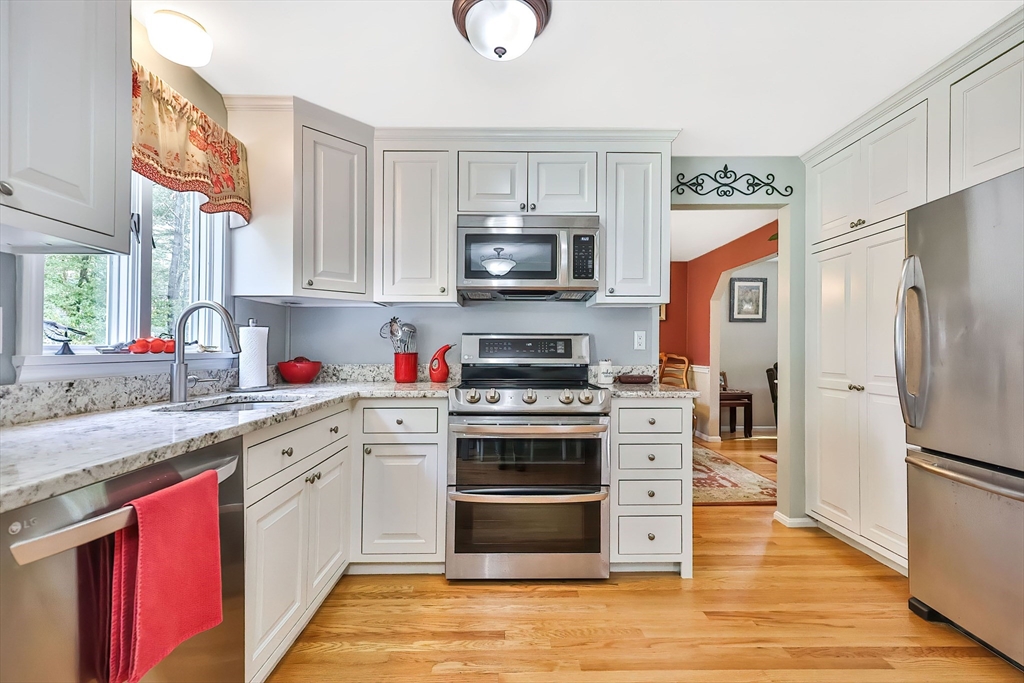 11 Puddingstone Lane Medway, MA 02053 - Photo 12 of 40 a kitchen with stainless steel appliances granite countertop a stove a sink and a refrigerator