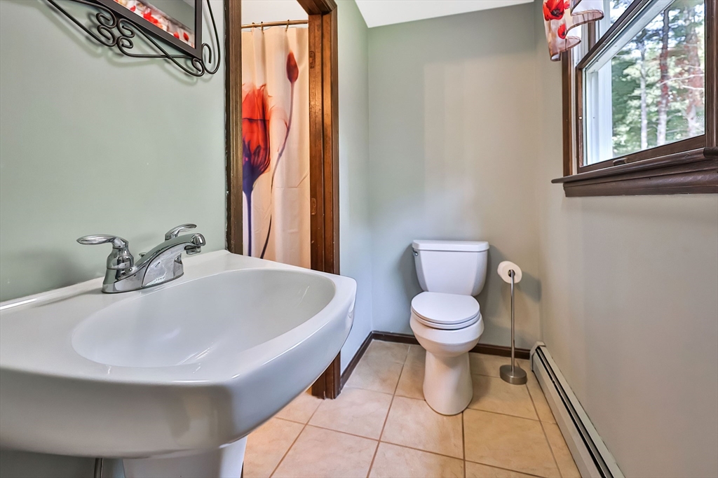 11 Puddingstone Lane Medway, MA 02053 - Photo 19 of 40 a bathroom with a sink a toilet and a mirror