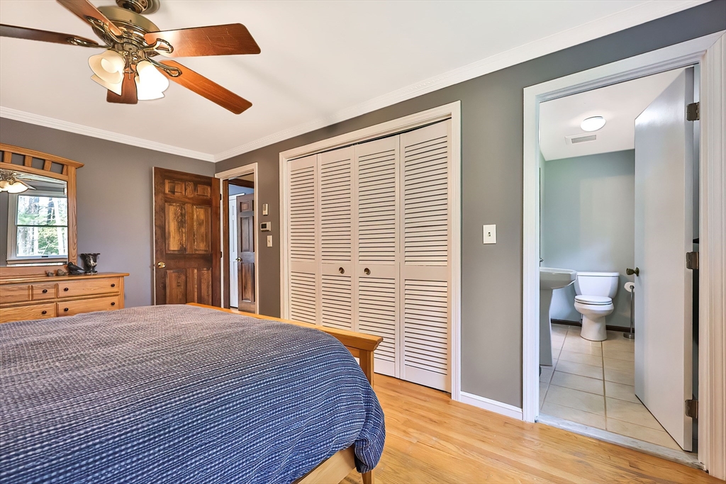 11 Puddingstone Lane Medway, MA 02053 - Photo 20 of 40 a bedroom with a bed and a chandelier