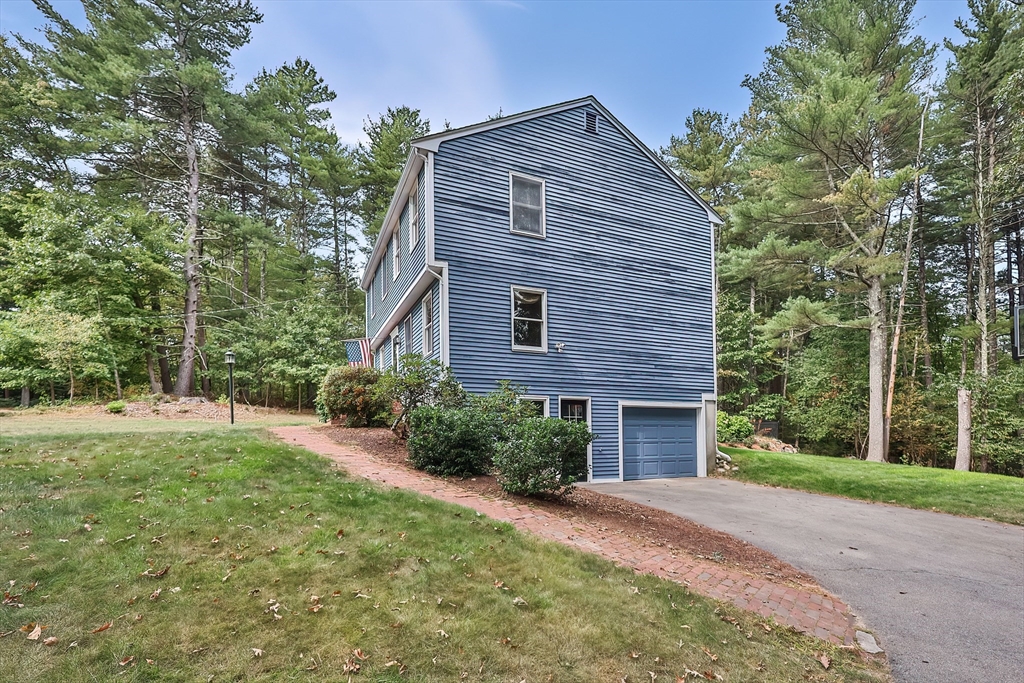 11 Puddingstone Lane Medway, MA 02053 - Photo 4 of 40 a front view of a house with a yard and trees