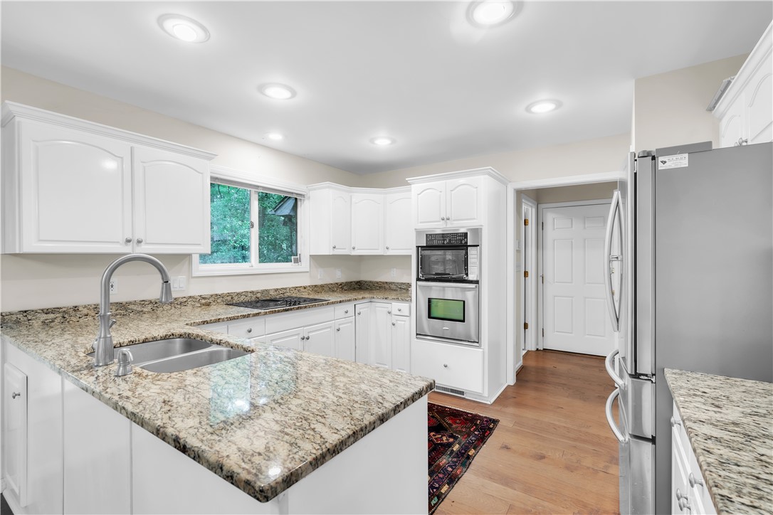 149 Inlet Pointe Drive Anderson, SC 29625 - Photo 7 of 43 Granite counters and stainless steel appliances complete this well-appointed kitchen, ready for culinary creations.
