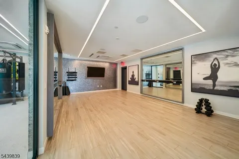 a living room with patio furniture and kitchen view
