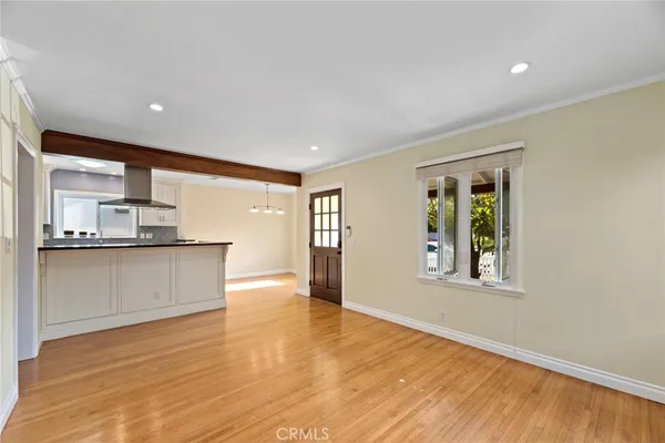 a view of kitchen with stainless steel appliances granite countertop a stove top oven a sink dishwasher and a refrigerator with wooden floor