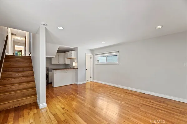 a view of a room with wooden floor and staircase