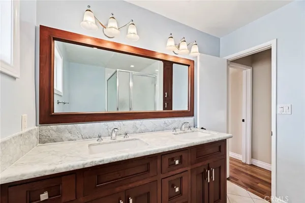 a bathroom with a double vanity sink and a mirror