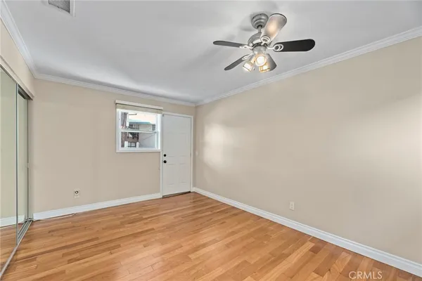 a view of a room with wooden floor and fan