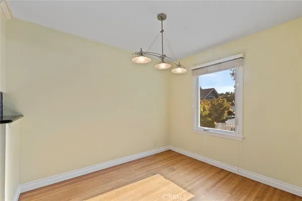 a view of a room with a large window and ceiling fan