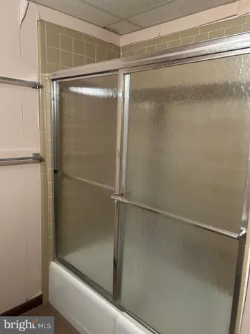 a bathroom with a glass shower door