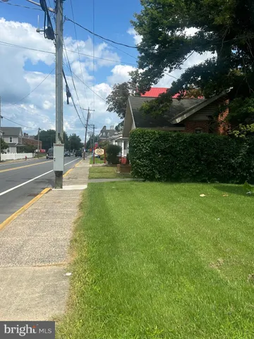 a view of a street with a building in the background