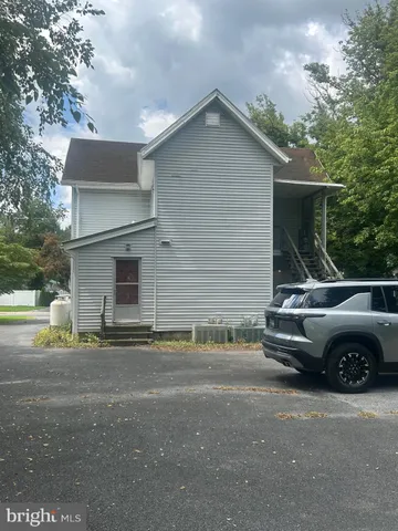 a view of a car parked in front of a house