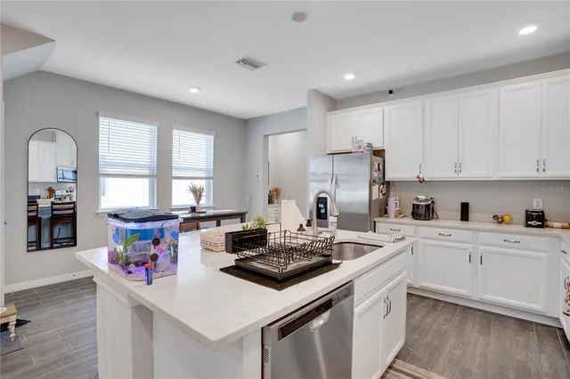 a kitchen that has a sink stove and cabinets