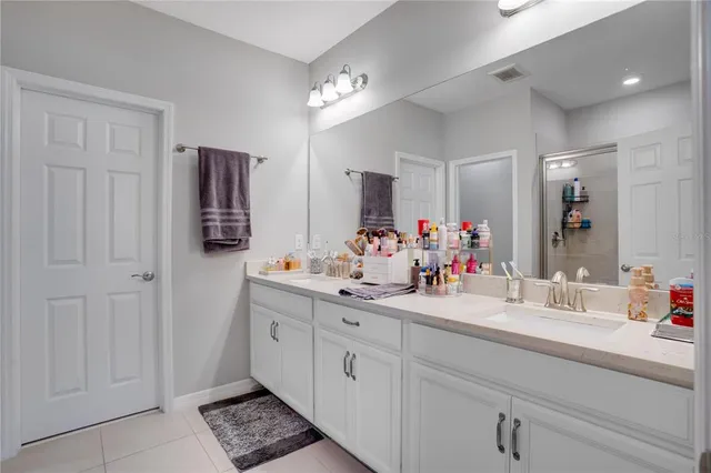 a bathroom with a sink double vanity and a mirror