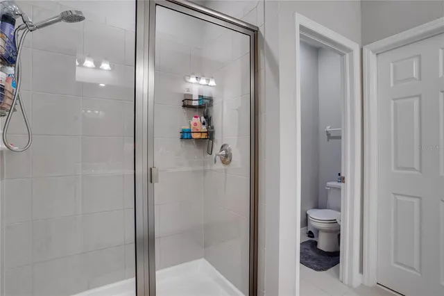 a bathroom with a glass shower door