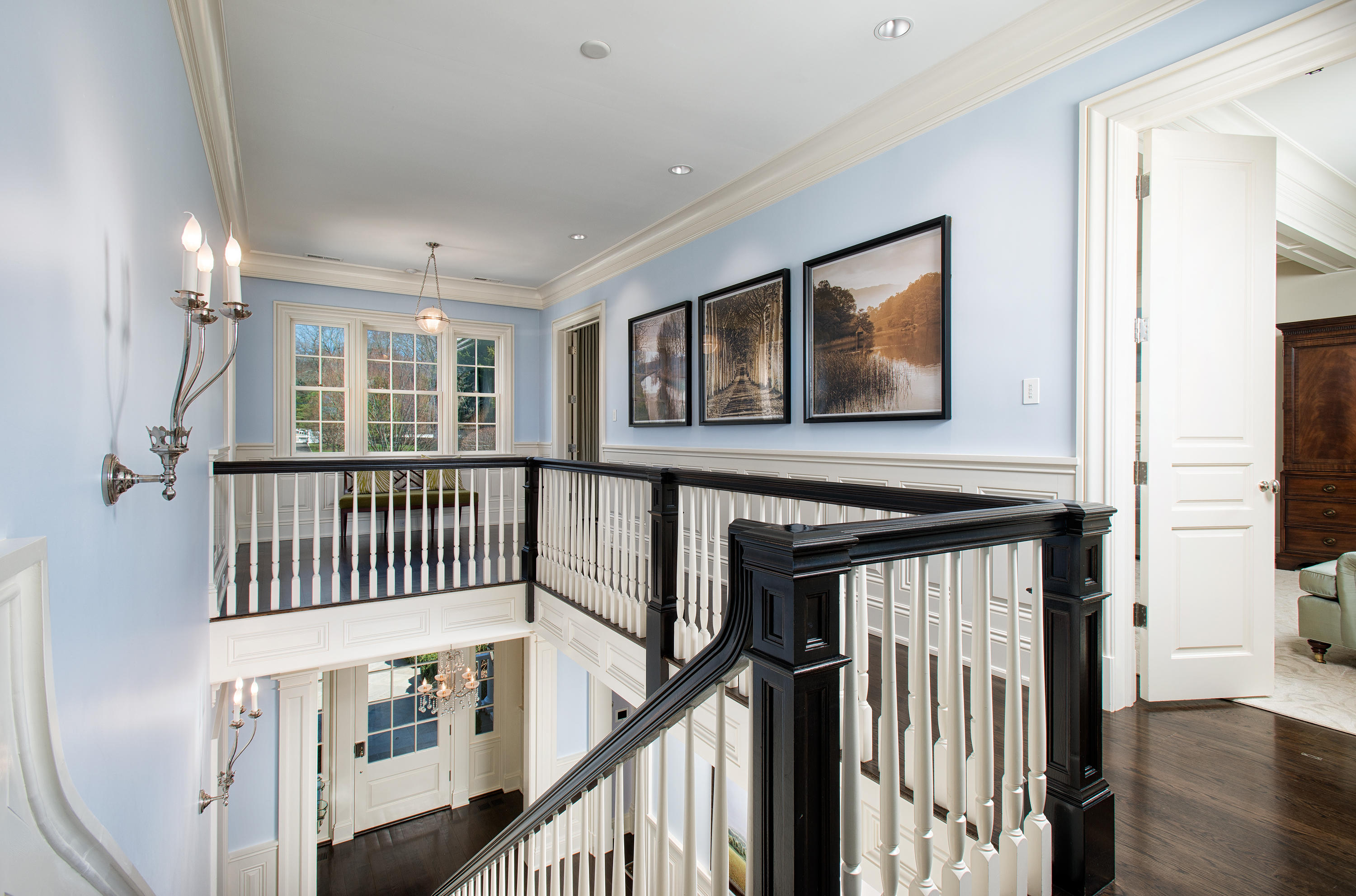 1480 Ponus Ridge Road New Canaan, CT 06840 - Photo 12 of 22 a view of a hallway with wooden floor and windows
