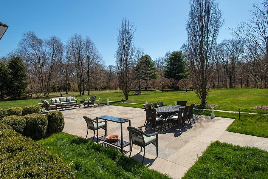 1480 Ponus Ridge Road New Canaan, CT 06840 - Photo 19 of 22 a view of a patio with chairs and a table