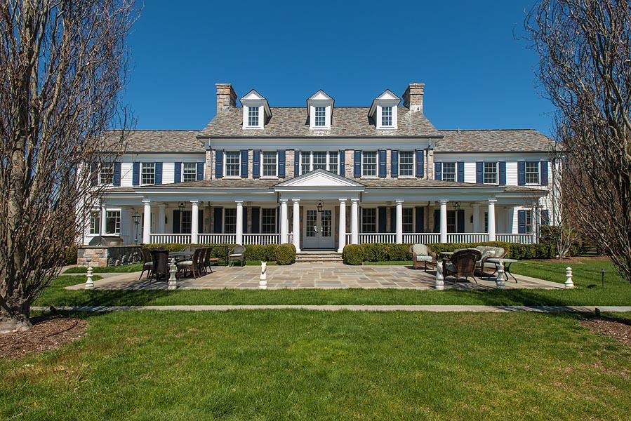 1480 Ponus Ridge Road New Canaan, CT 06840 - Photo 20 of 22 a front view of a house with a garden
