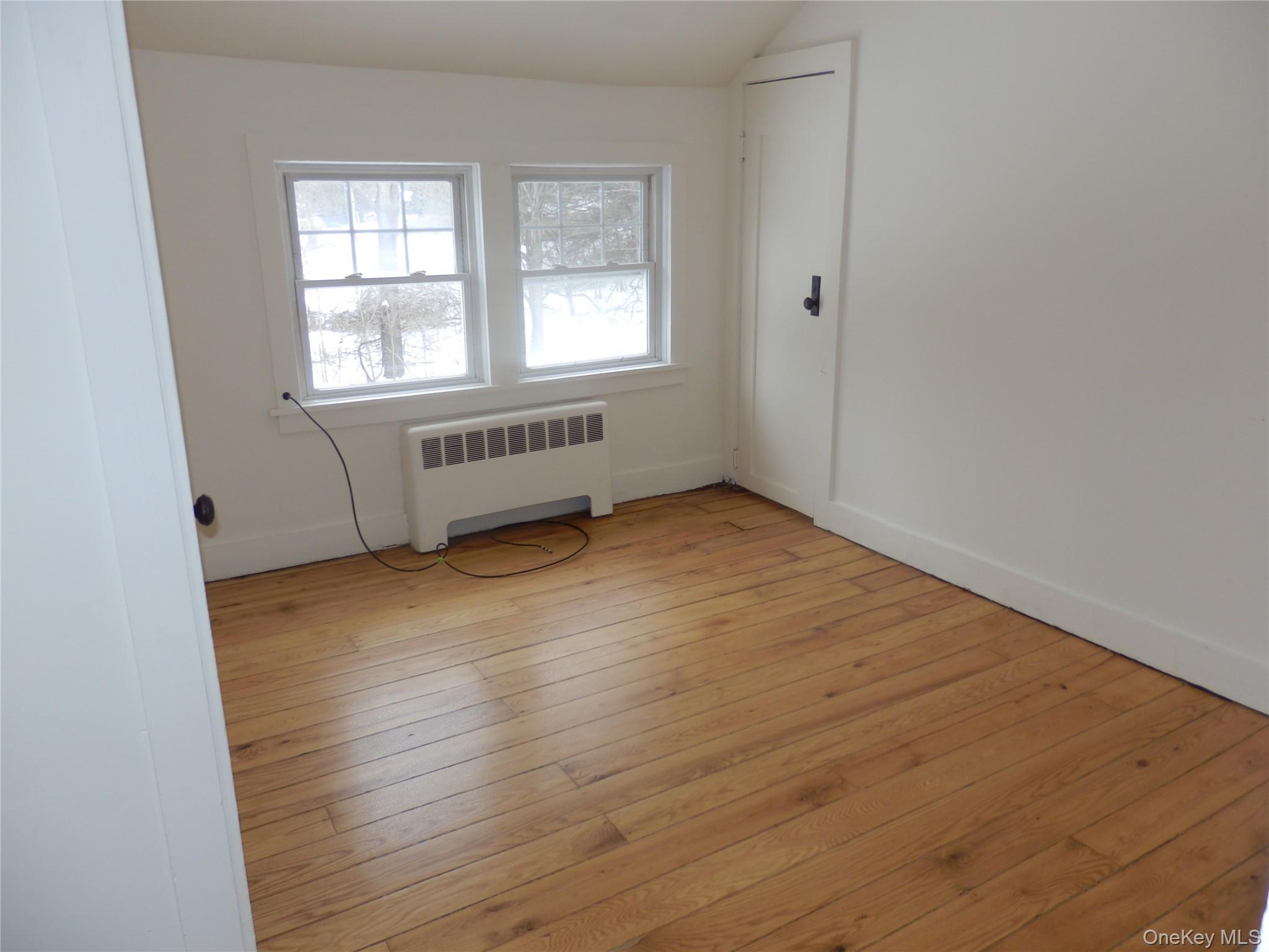 762 Old Rte 22 Amenia, NY 12501 - Photo 13 of 25 an empty room with wooden floor and windows