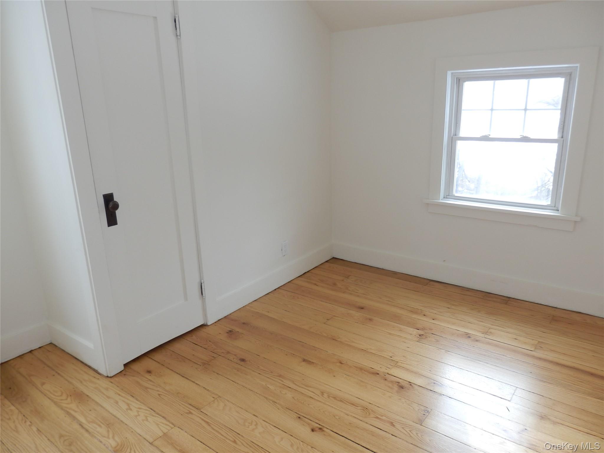 762 Old Rte 22 Amenia, NY 12501 - Photo 19 of 25 an empty room with wooden floor and windows