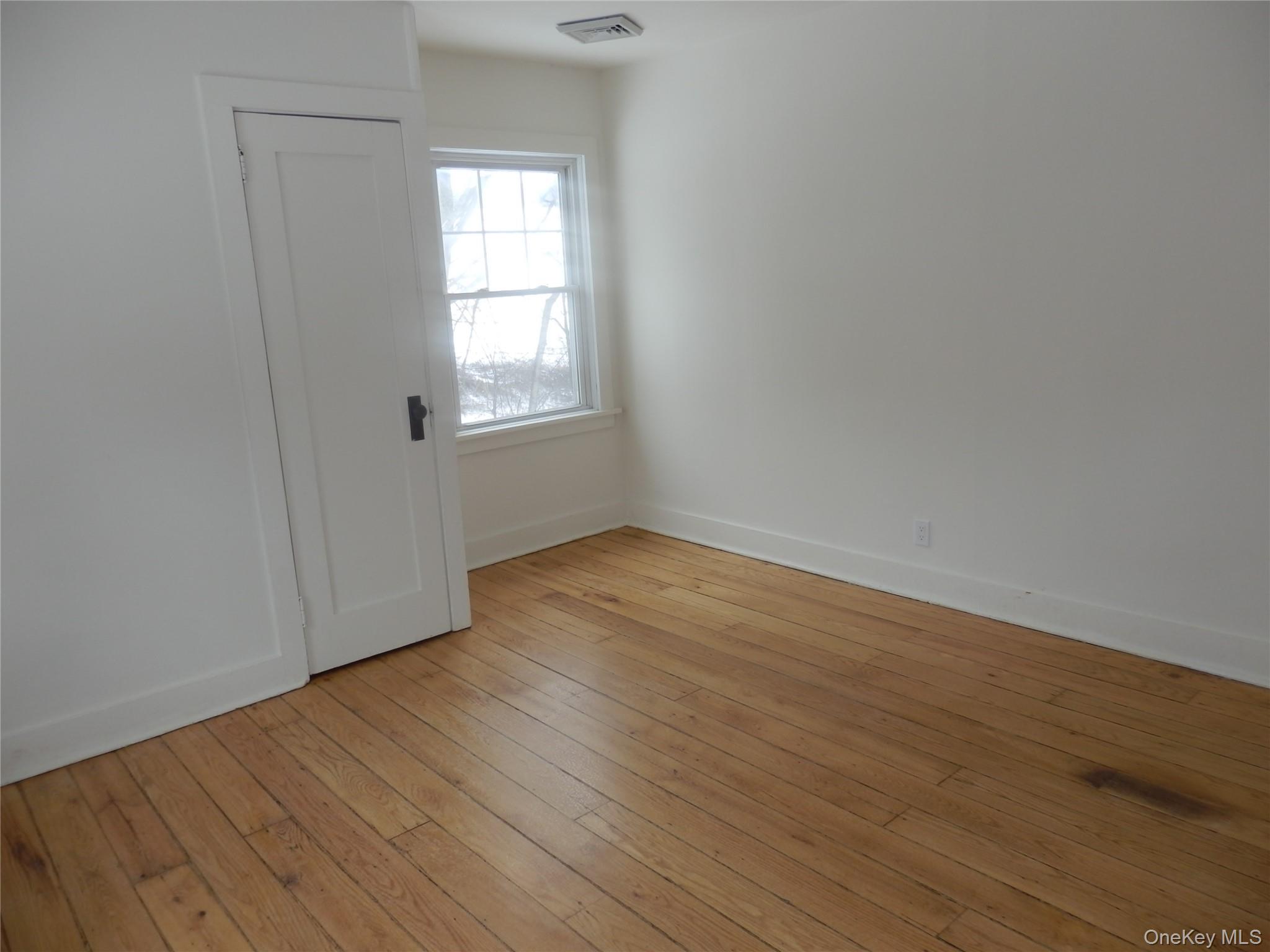 762 Old Rte 22 Amenia, NY 12501 - Photo 21 of 25 a view of an empty room with wooden floor and a window