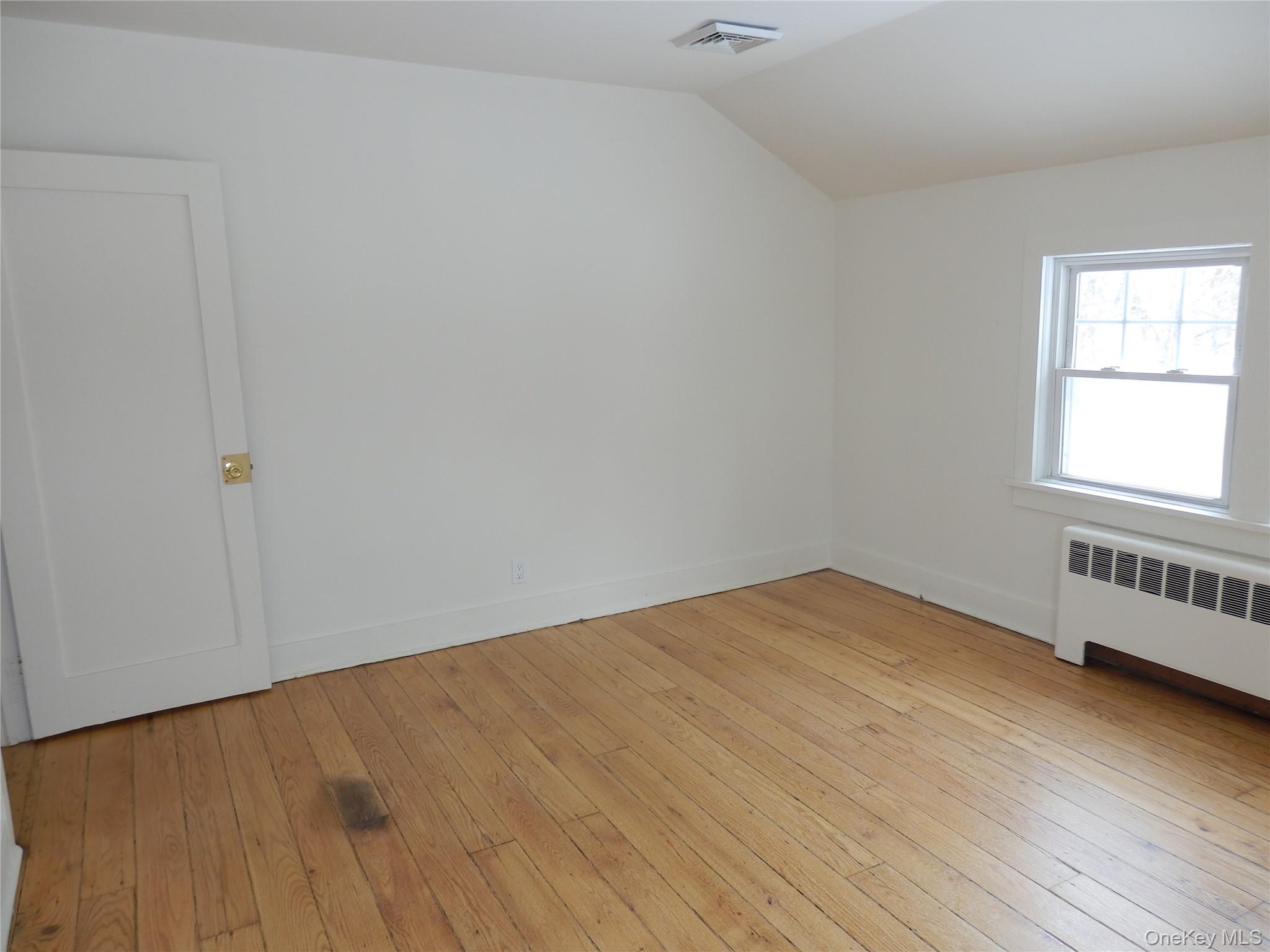 762 Old Rte 22 Amenia, NY 12501 - Photo 22 of 25 an empty room with wooden floor and windows
