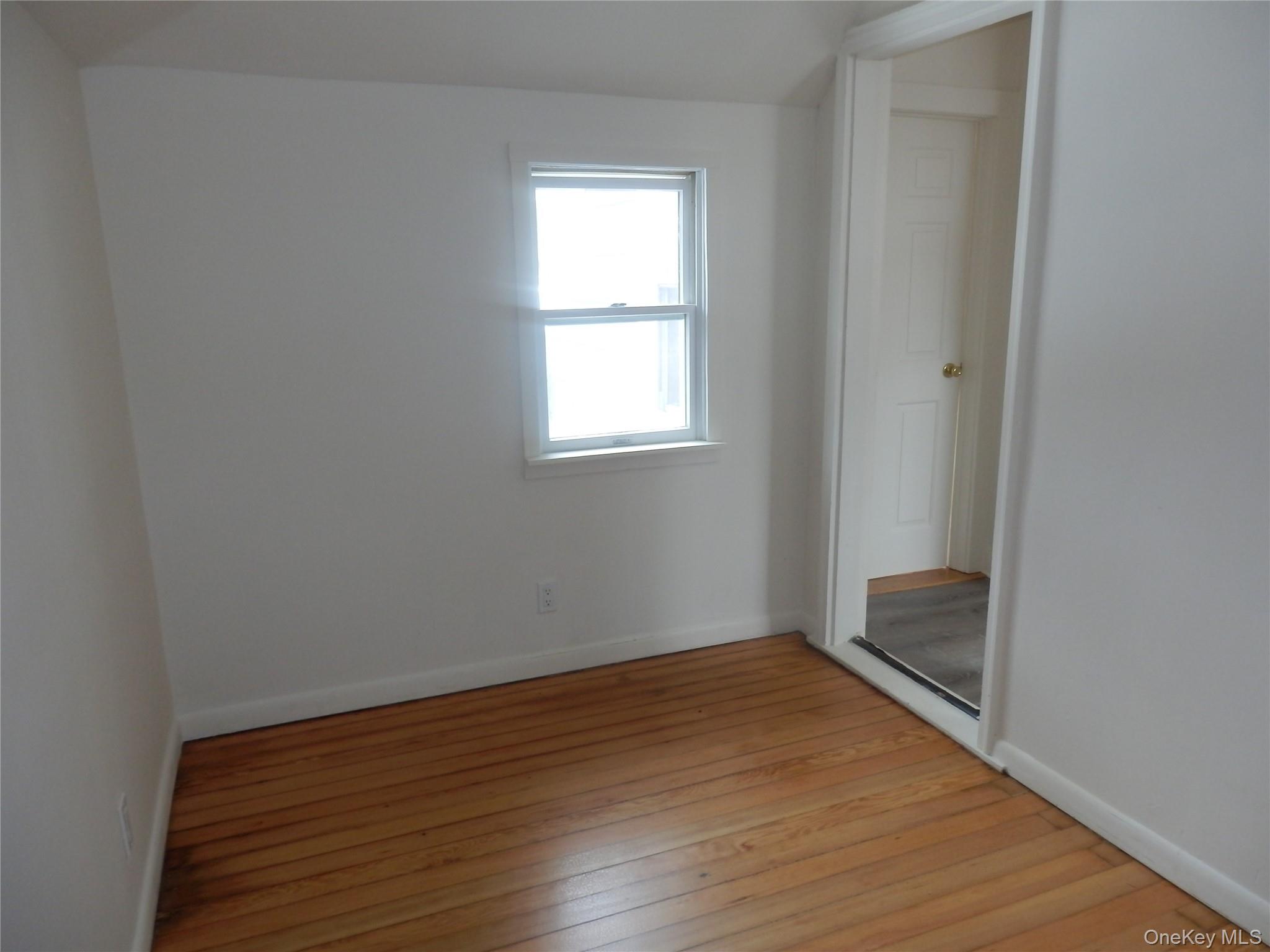 762 Old Rte 22 Amenia, NY 12501 - Photo 24 of 25 an empty room with wooden floor and windows