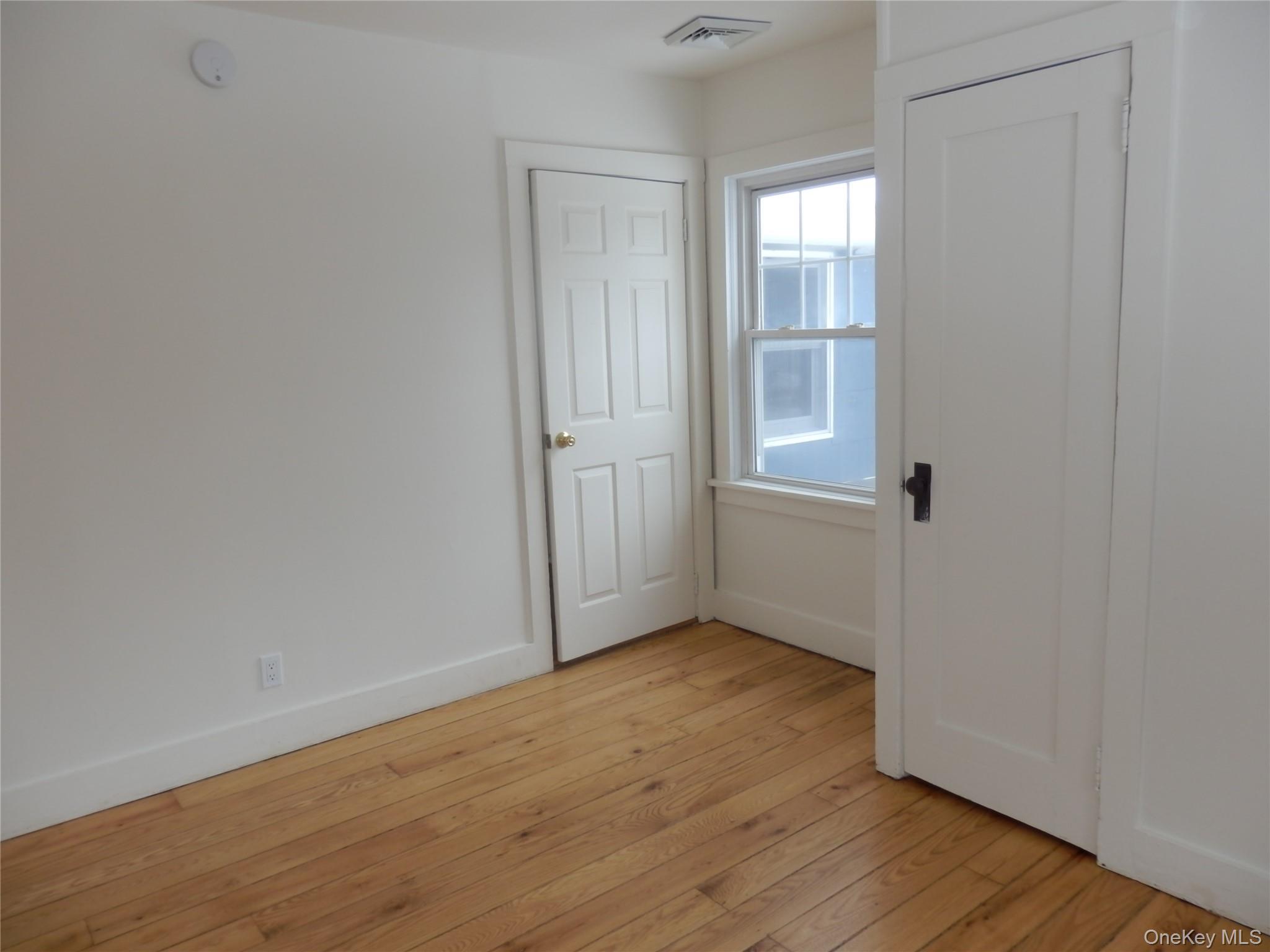 762 Old Rte 22 Amenia, NY 12501 - Photo 25 of 25 a view of an empty room with wooden floor and a window
