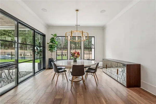 a view of a dining room with furniture window and wooden floor