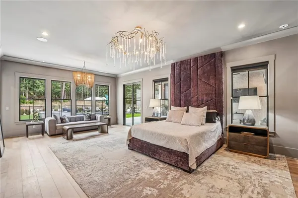 a bedroom with furniture and a large window