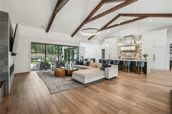a living room with furniture and wooden floor
