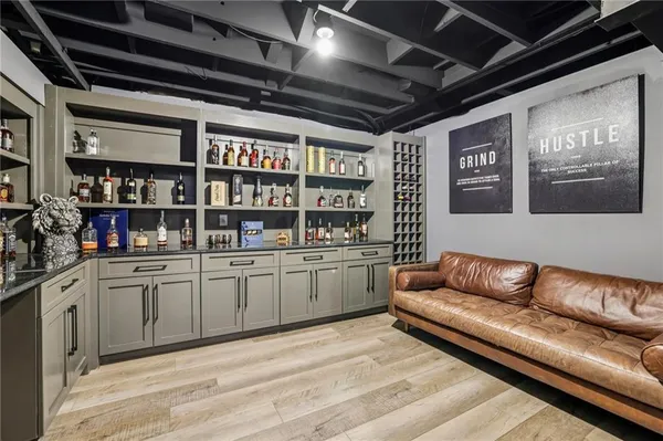 a view of a room with wooden floor and furniture