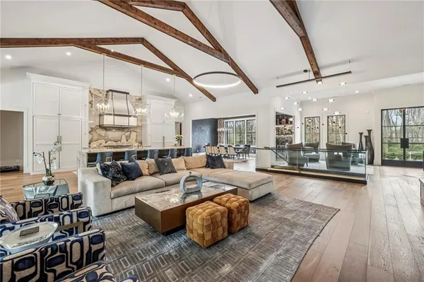 a living room with furniture wooden floor and a table