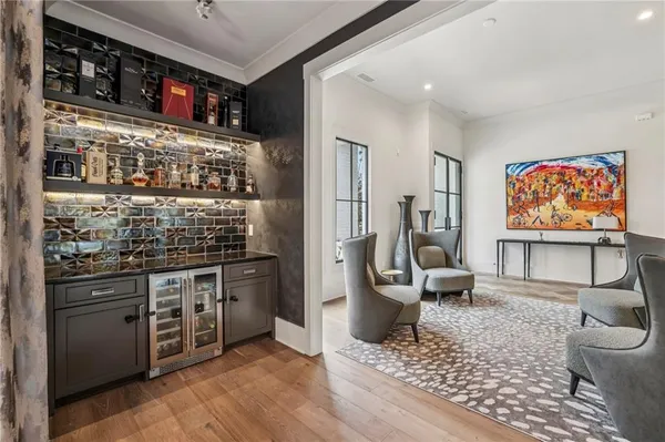 a living room with stainless steel appliances kitchen island granite countertop a stove and a refrigerator