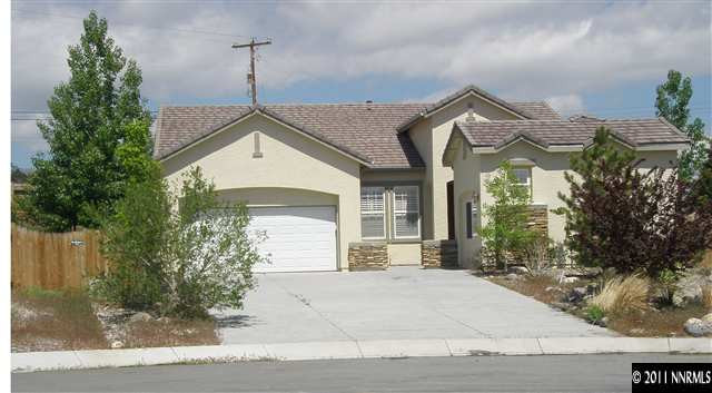 1794 Kodiak Circle Reno, NV 89511 - Photo 1 of 13 a front view of a house with a yard and garage