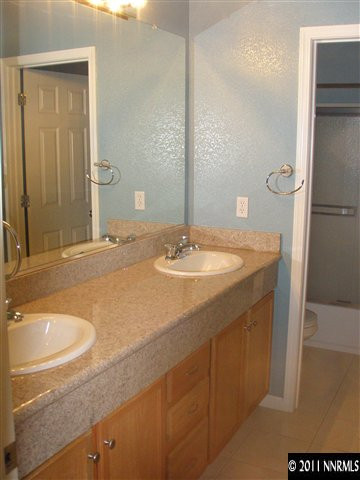 1794 Kodiak Circle Reno, NV 89511 - Photo 9 of 13 a bathroom with a sink and a mirror