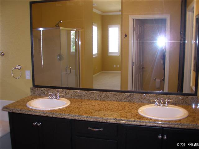 1794 Kodiak Circle Reno, NV 89511 - Photo 10 of 13 a bathroom with a granite countertop sink and a mirror
