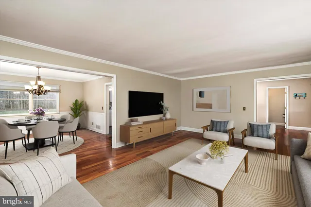 a dining room with furniture a chandelier and wooden floor